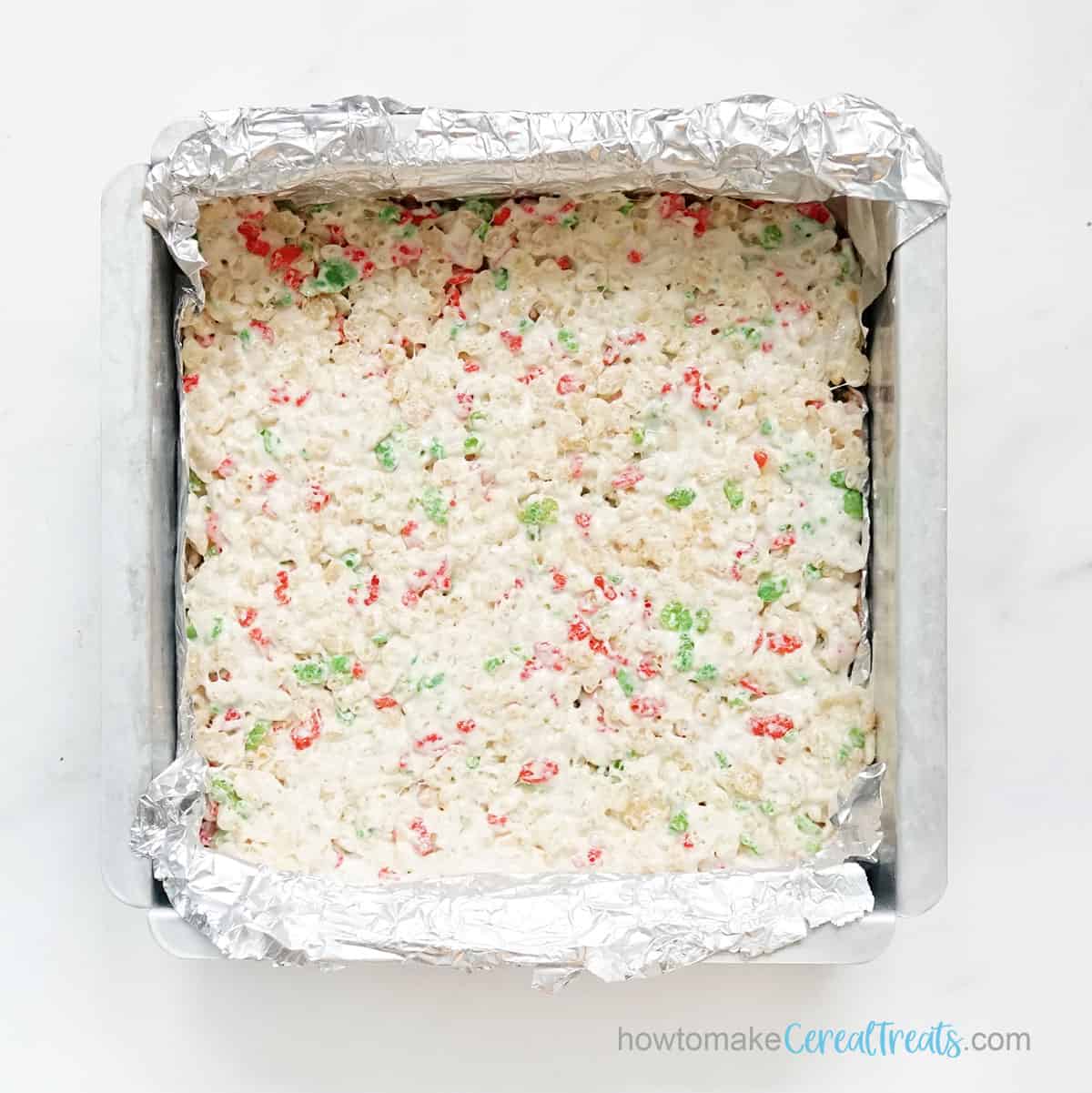 Red and green holiday Rice Krispie Treats in baking pan