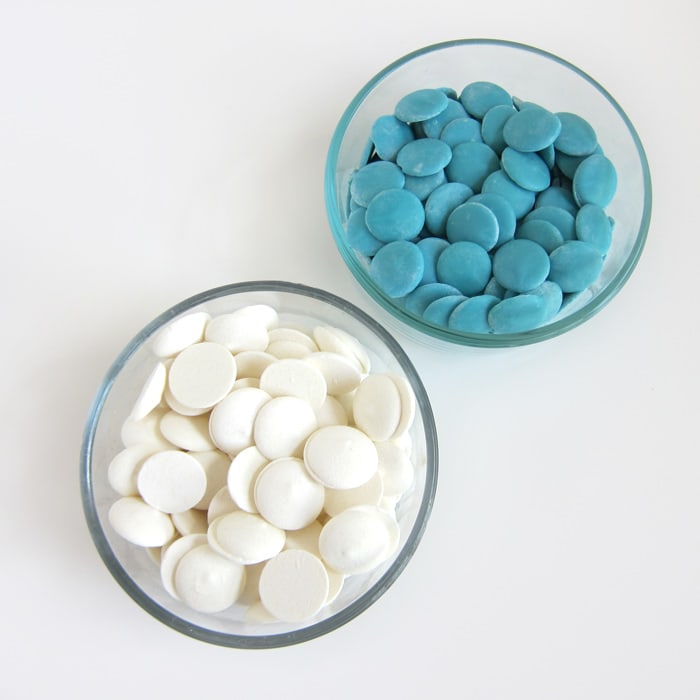 bowls of white and blue candy melt wafers.