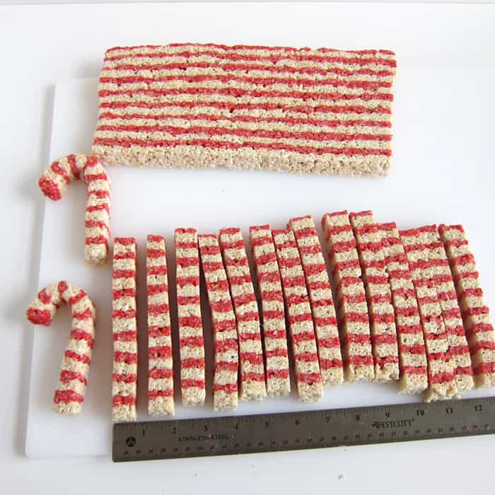 shaping striped white and red Rice Krispie Treats into candy canes.