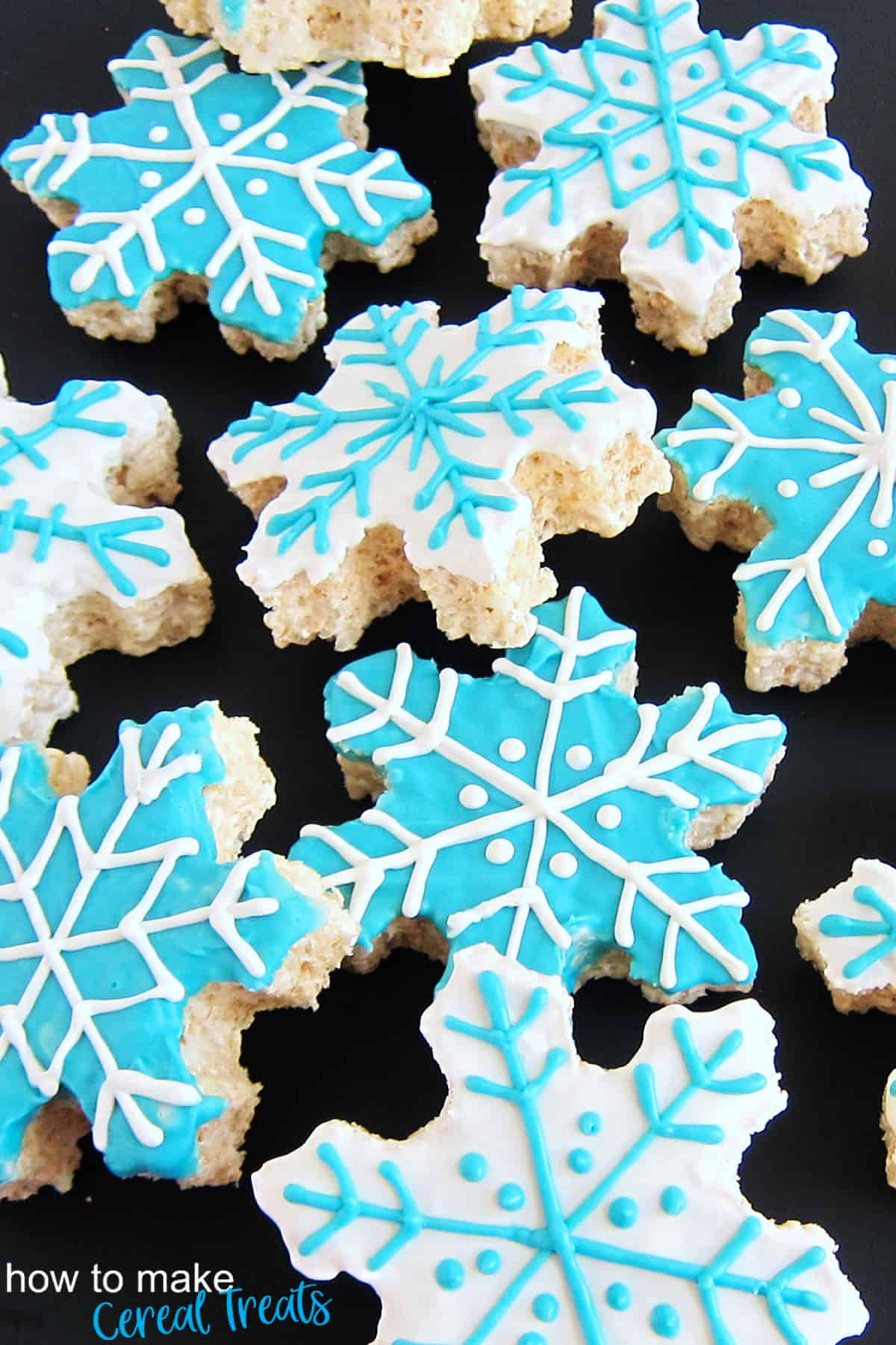 white and blue Rice Krispie Treat snowflakes covered in white chocolate.