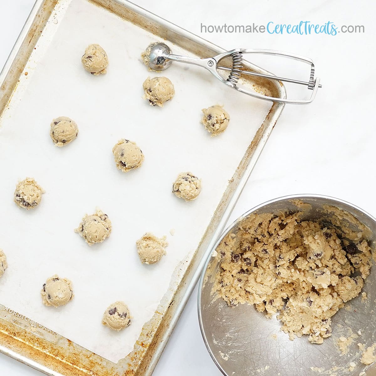 cookie scoop and rice krispie treat chocolate chip cookie dough on baking tray