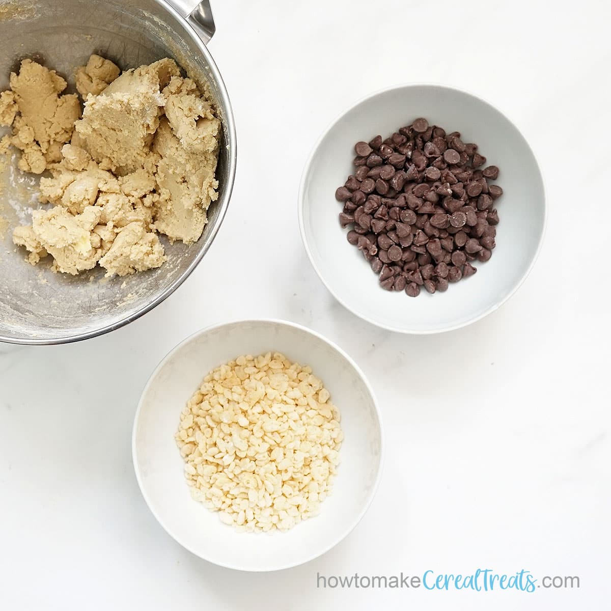 Bowls of Rice Krispies and chocolate chips with cookie dough
